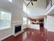 Bright living room with hardwood floors, fireplace, and open floor plan leading to the kitchen at 318 S Bend Dr, Durham, NC 27713