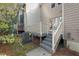 Exterior view of the back of the property, with a wood deck and stairs to the backyard at 3213 Coachmans Way, Durham, NC 27705