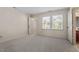 Spacious bedroom with two windows providing natural light and an attached bathroom at 3213 Coachmans Way, Durham, NC 27705