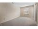 Bright bedroom with neutral carpet, window, and ample space for furniture at 3213 Coachmans Way, Durham, NC 27705