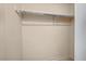 A functional walk-in closet equipped with a chrome clothing rod and ample storage space at 3213 Coachmans Way, Durham, NC 27705