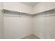 Compact closet with shelving and a chrome clothing rod, providing efficient storage at 3213 Coachmans Way, Durham, NC 27705