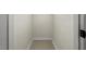 Small walk-in closet featuring neutral carpet and white walls at 3213 Coachmans Way, Durham, NC 27705