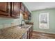 Kitchen featuring granite countertops, stainless steel appliances, and wood cabinets at 3213 Coachmans Way, Durham, NC 27705