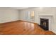 Bright living area with hardwood floors, fireplace, and sliding glass door to outdoor deck at 3213 Coachmans Way, Durham, NC 27705