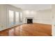 Spacious living room with hardwood floors, a fireplace, and access to an outdoor patio at 3213 Coachmans Way, Durham, NC 27705