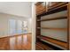 Bright living area featuring hardwood floors, a built-in bookshelf, and glass doors to the exterior at 3213 Coachmans Way, Durham, NC 27705