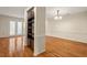 Open-concept living room with hardwood flooring, built-in shelving, and ample natural light at 3213 Coachmans Way, Durham, NC 27705