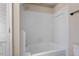 Clean tiled shower-tub featuring classic fixtures and a neutral color scheme at 3213 Coachmans Way, Durham, NC 27705
