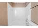 Clean, white tiled shower-tub featuring classic fixtures and a neutral color scheme at 3213 Coachmans Way, Durham, NC 27705