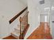 Staircase with wooden railing and carpeted steps leading to the second floor at 3213 Coachmans Way, Durham, NC 27705