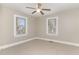 Bedroom featuring neutral walls, carpet, a ceiling fan, and two windows at 328 Cleveland St, Rocky Mount, NC 27803