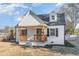 Charming two-story home featuring a cozy front porch with wooden pillars and dark shutters at 328 Cleveland St, Rocky Mount, NC 27803