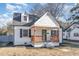 Charming two-story home featuring a cozy front porch with wooden pillars and dark shutters at 328 Cleveland St, Rocky Mount, NC 27803