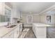 Modern kitchen with white cabinets, stainless steel appliances, and an island with white countertop at 328 Cleveland St, Rocky Mount, NC 27803