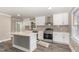 Modern kitchen with white cabinets, stainless steel appliances, and an island with white countertop at 328 Cleveland St, Rocky Mount, NC 27803