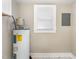 Well-lit utility room features a modern water heater, electrical panel and tiled floor at 328 Cleveland St, Rocky Mount, NC 27803