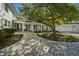 Lush backyard featuring a brick pathway, a mature tree, and a view of the home's exterior at 330 Tenney Circle, Chapel Hill, NC 27514