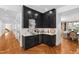 Modern bar area featuring black cabinets, marble countertops, wine storage, and ample room for entertaining at 330 Tenney Circle, Chapel Hill, NC 27514
