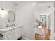 Bright bathroom with white walls, hardwood floors, and a white vanity that opens into a bedroom at 330 Tenney Circle, Chapel Hill, NC 27514