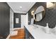 Modern bathroom with patterned wallpaper, hardwood floors, and a gray vanity with stylish fixtures at 330 Tenney Circle, Chapel Hill, NC 27514