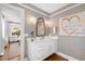 Elegant bathroom features patterned wallpaper, hardwood floors, and a white vanity with stylish fixtures at 330 Tenney Circle, Chapel Hill, NC 27514