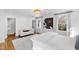 Bright bedroom features white walls, hardwood floors, and a seating area near the ensuite bathroom at 330 Tenney Circle, Chapel Hill, NC 27514