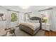 Bright bedroom features large windows and a stylish gray upholstered bed frame with gold trim at 330 Tenney Circle, Chapel Hill, NC 27514
