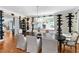 Bright dining room with dark table, white chairs, unique modern chandelier, and artistic wall details at 330 Tenney Circle, Chapel Hill, NC 27514