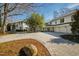 Sprawling two-story home with circular driveway, covered porch, and lush landscaping at 330 Tenney Circle, Chapel Hill, NC 27514