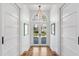 Bright foyer with herringbone wood floors, an arched doorway, and double glass doors leading to the exterior at 330 Tenney Circle, Chapel Hill, NC 27514