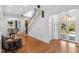 Inviting foyer with hardwood floors, staircase, decorative chair and table, and arched doorways to other rooms at 330 Tenney Circle, Chapel Hill, NC 27514