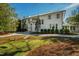 Elegant two-story home showcasing a swing and lush front yard landscaping, inviting walkway, and white exterior at 330 Tenney Circle, Chapel Hill, NC 27514