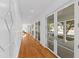 Bright hallway with white walls, hardwood floors, and many doors with windows that bring in lots of light at 330 Tenney Circle, Chapel Hill, NC 27514