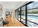 Bright hallway with large sliding glass doors opening to a pool area with lounge chairs at 330 Tenney Circle, Chapel Hill, NC 27514