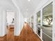 Bright, long hallway featuring light wood flooring, decorative geometric wall, and glass-paneled doors at 330 Tenney Circle, Chapel Hill, NC 27514