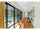 Hallway leading to the pool with black framed sliding glass doors and chairs at 330 Tenney Circle, Chapel Hill, NC 27514
