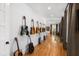 Hallway featuring guitars on display along the walls and hardwood flooring at 330 Tenney Circle, Chapel Hill, NC 27514