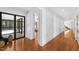 Elegant hallway with light wood floors and decorative geometric wall; open to additional living areas at 330 Tenney Circle, Chapel Hill, NC 27514