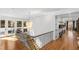 Elegant hallway with hardwood floors, staircase, and a unique chandelier, leading to various rooms at 330 Tenney Circle, Chapel Hill, NC 27514