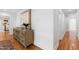 Hallway with hardwood floors and decorative dresser at 330 Tenney Circle, Chapel Hill, NC 27514