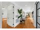 Bright hallway with hardwood floors, white wainscotting, and view of the living room at 330 Tenney Circle, Chapel Hill, NC 27514