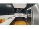 Modern kitchen features dark cabinetry, wine cooler, white countertops, patterned backsplash, and wood floors at 330 Tenney Circle, Chapel Hill, NC 27514