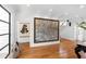 Living room with herringbone floors, decorative art, and staircase access at 330 Tenney Circle, Chapel Hill, NC 27514