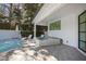 Backyard outdoor living area featuring a swimming pool, hot tub, lounge chairs, and covered patio at 330 Tenney Circle, Chapel Hill, NC 27514