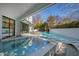 Outdoor swimming pool with hot tub, white brick privacy wall and outdoor seating area at 330 Tenney Circle, Chapel Hill, NC 27514