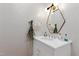 Chic powder room with textured walls, a modern mirror, and a sleek vanity with stylish fixtures at 330 Tenney Circle, Chapel Hill, NC 27514
