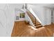 Beautiful staircase with hardwood steps, black iron railing, and decorative wall paneling at 330 Tenney Circle, Chapel Hill, NC 27514