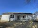 Back exterior view of the home featuring a new concrete patio and level lot at 343 Magnolia Run Way, Benson, NC 27504
