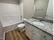 Bathroom featuring a single vanity with granite countertop, bathtub, and shower at 343 Magnolia Run Way, Benson, NC 27504